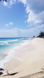 Scenic view of beach against blue sky