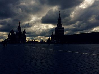 Silhouette of church against cloudy sky