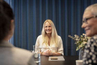 Smiling woman at business meeting