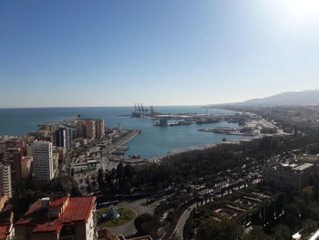 High angle view of bay and buildings against clear sky