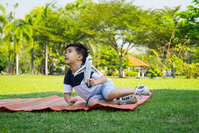 Boy with toy airplane at park