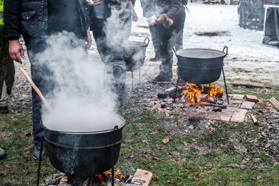 Preparing traditional romanian food at  cauldron on the open fire, christmas tradition