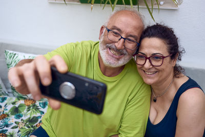 Portrait of a smiling young woman using mobile phone