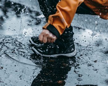 Low section of man splashing water