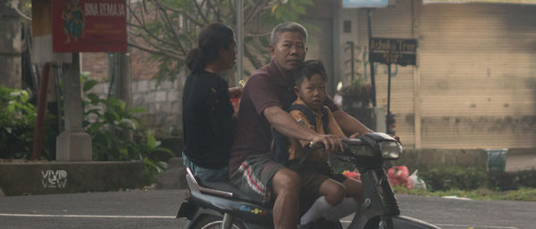 People riding motorcycle on road