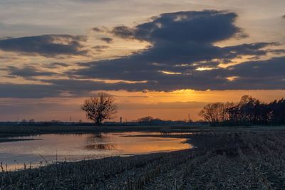 Scenic view of lake against orange sky during sunset