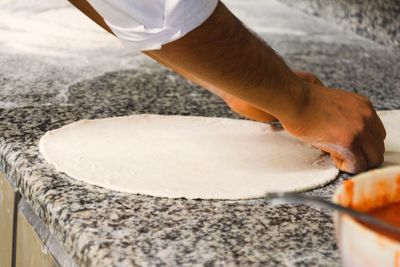 Cropped hands of male chef preparing food in kitchen