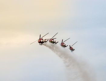 Low angle view of helicopters in sky during air show