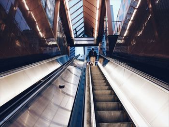 Rear view of man on escalator