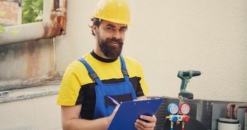 Portrait of man standing in factory