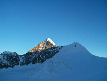 Scenic view of snowcapped mountains against clear blue sky