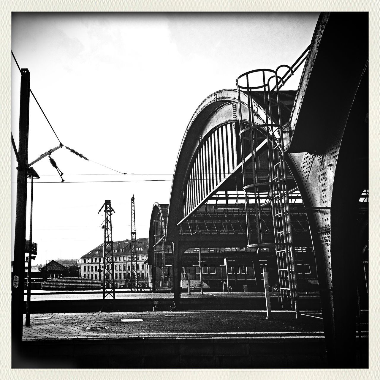 architecture, built structure, transfer print, railing, low angle view, building exterior, sky, auto post production filter, metal, steps, staircase, connection, steps and staircases, power line, clear sky, day, railroad track, no people, outdoors, rail transportation