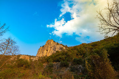 Low angle view of mountain against blue sky