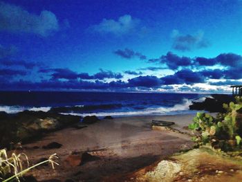 Scenic view of beach against blue sky