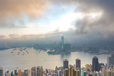 Panoramic view of bay and buildings against sky