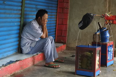 Side view of woman sitting on seat