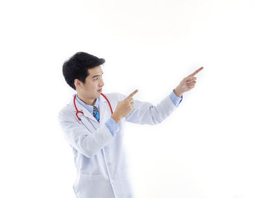 Young man looking away over white background