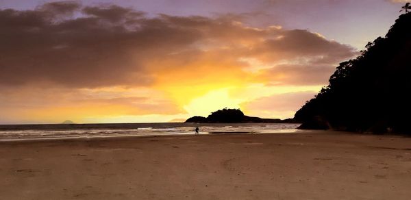 Scenic view of beach against sky during sunset