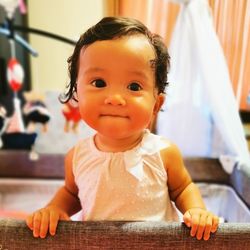 Portrait of cute baby girl at home