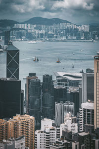 High angle view of city by sea against sky