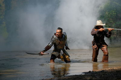 Full length of men standing on shore