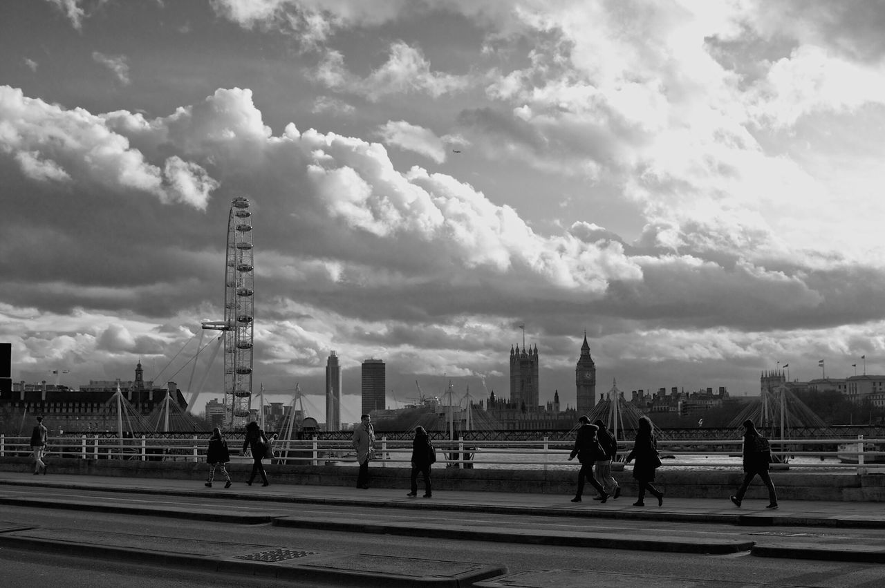sky, cloud - sky, built structure, architecture, cloudy, men, building exterior, city, person, large group of people, lifestyles, cloud, leisure activity, road, city life, street, walking, street light, transportation