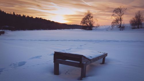Scenic view of snow covered landscape during sunset