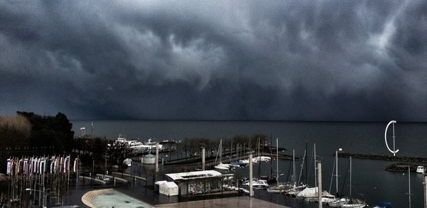 Harbor against cloudy sky