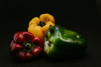 Close-up of bell peppers against black background