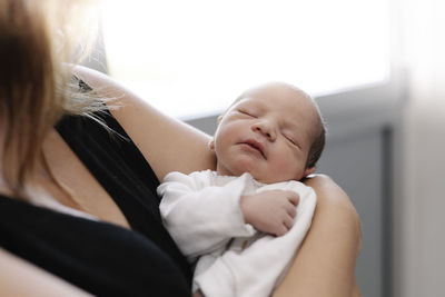 Mother with newborn baby at home