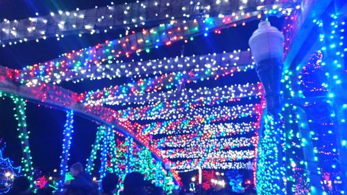 Low angle view of illuminated lights at night