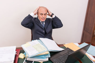 Young man sitting in a stack of a room