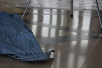 High angle view of denim shirt on floor