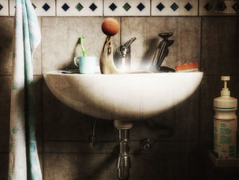 Image montage of seal playing with basketball in faucet in bathroom