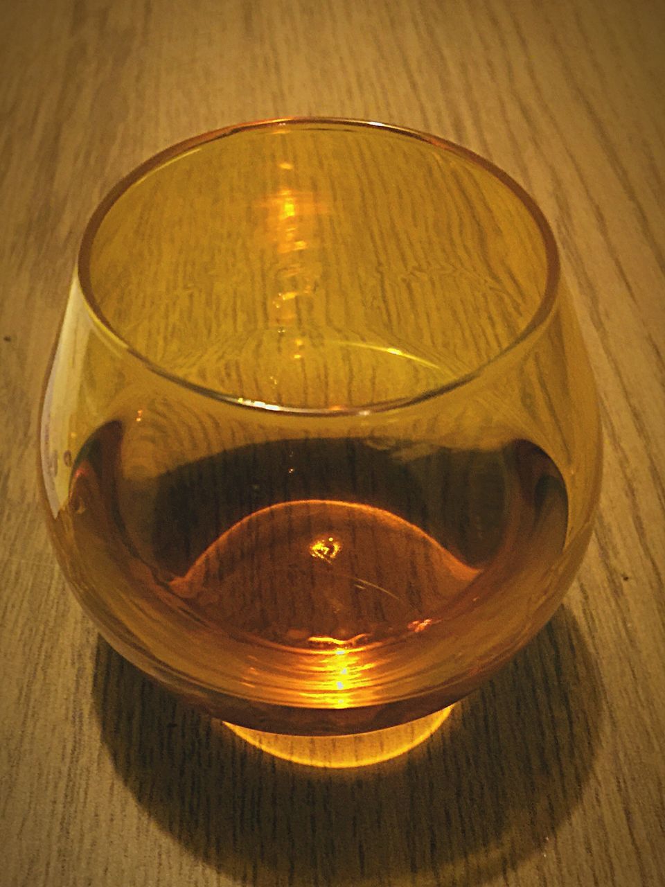 indoors, table, drink, glass - material, still life, drinking glass, refreshment, food and drink, wood - material, candle, transparent, wineglass, close-up, illuminated, alcohol, high angle view, reflection, glass, no people, burning