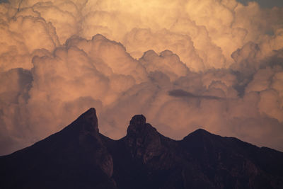 Low angle view of mountains against sky during sunset