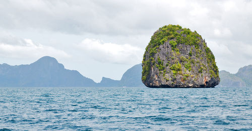 Scenic view of rocks in sea against sky