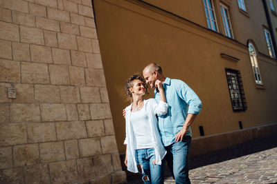 Full length of couple on building