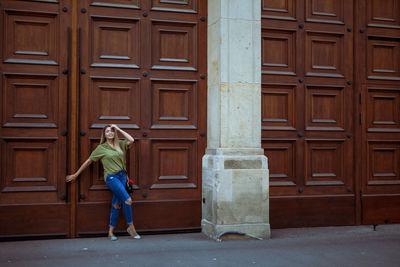 Full length of woman standing at entrance