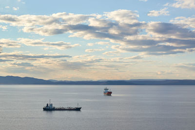 Boats on sea against sky during sunset