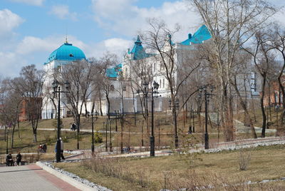 Panoramic view of trees and buildings against sky