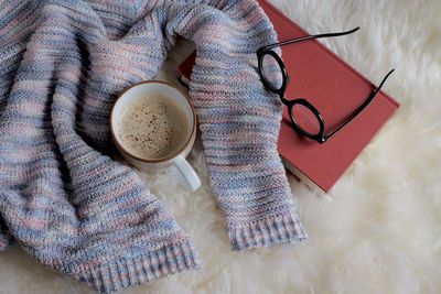 High angle view of coffee cup on bed