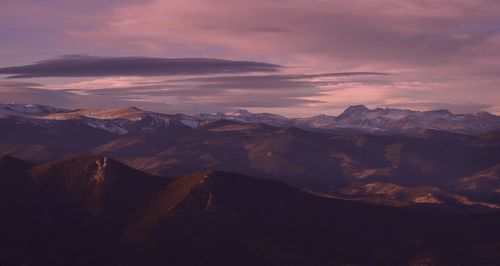 Scenic view of mountains against cloudy sky