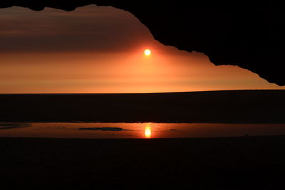 Scenic view of sea against orange sky