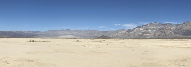 Scenic view of desert against blue sky