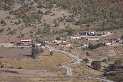 High angle view of houses and buildings against mountains