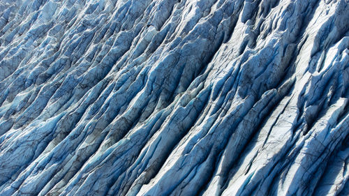 Vatnajokull glacier in iceland, pure blue ice texture at winter season, aerial top view landscape.