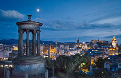 Illuminated cityscape against sky at night