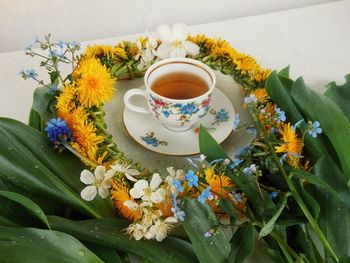 Close-up of tea amidst flowers on table