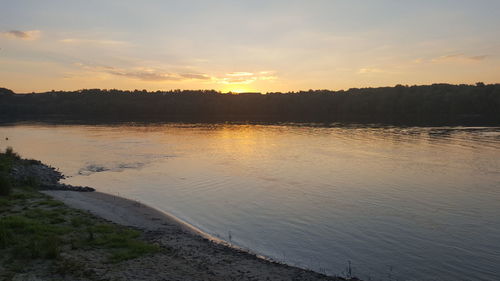 Scenic view of calm sea against sky during sunset